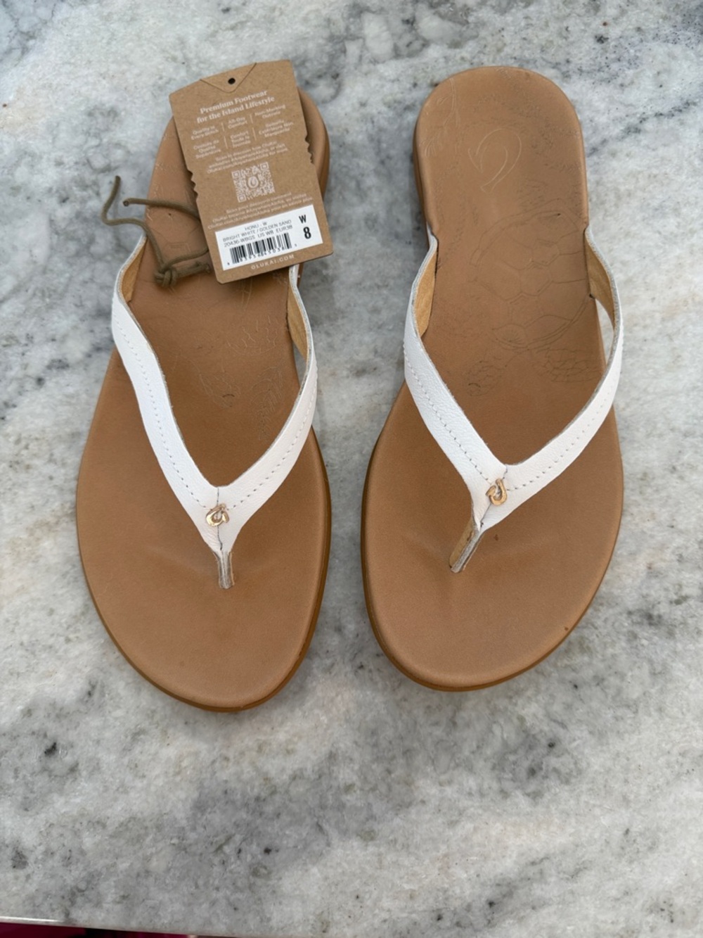 OluKai Women's White and Tan Leather Flip Flop Sandals